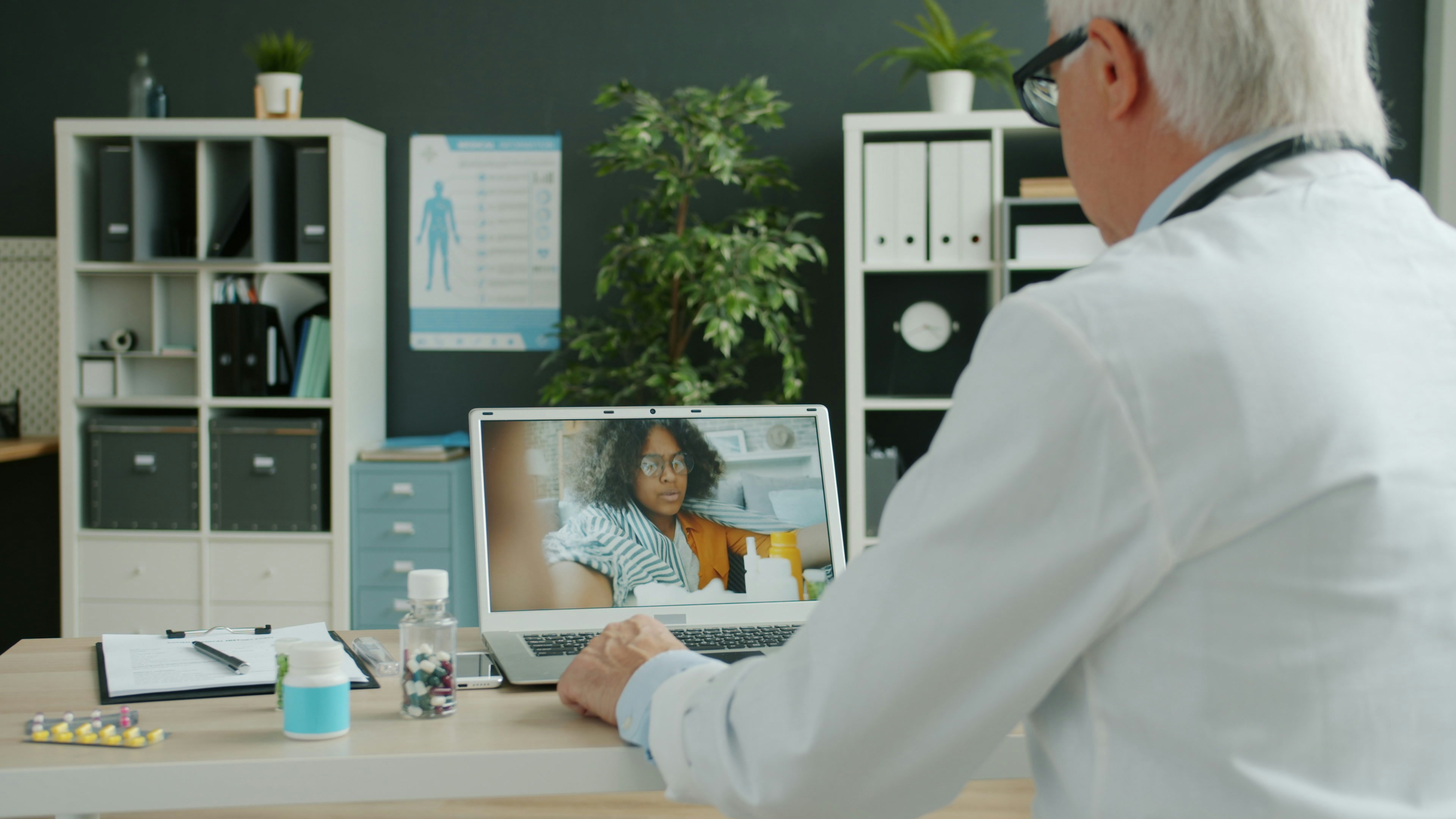 Doctor on a video call with a patient using a laptop, telehealth for seniors