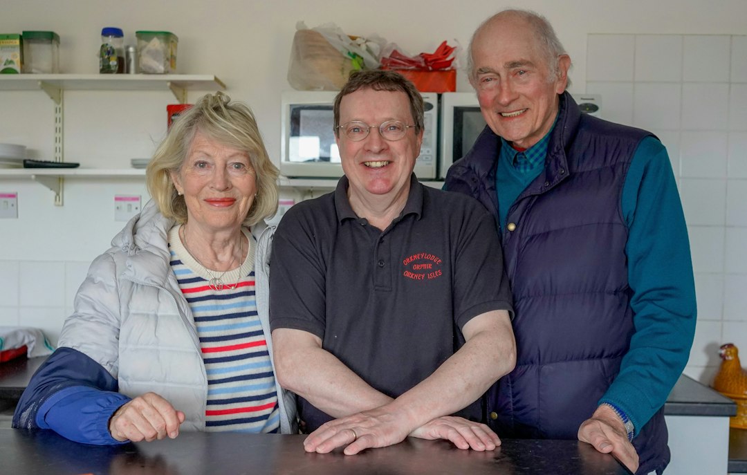 Smiling senior man giving thumbs up at home, independent living