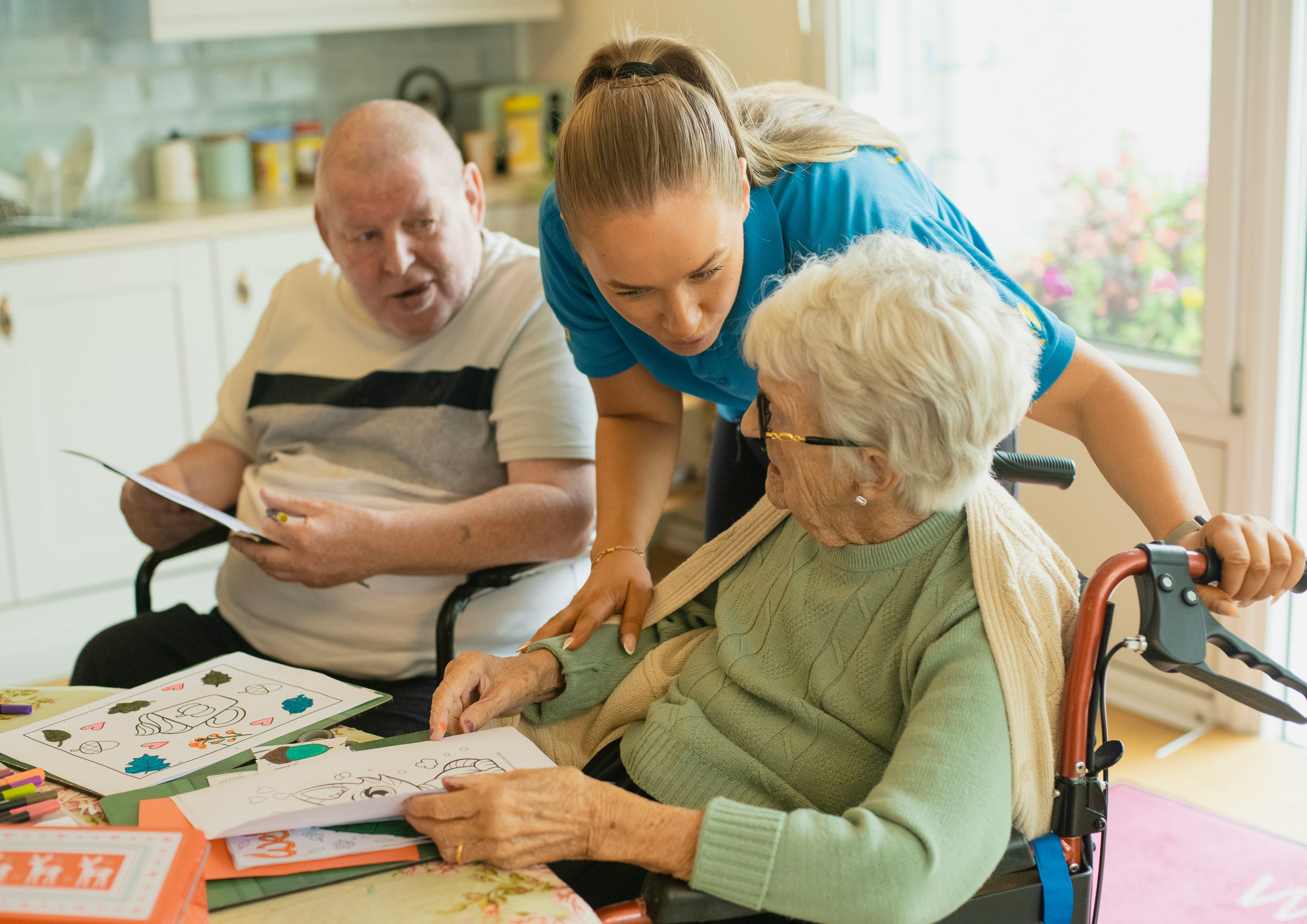 Nurse assisting elderly residents during an activity, professional home care support