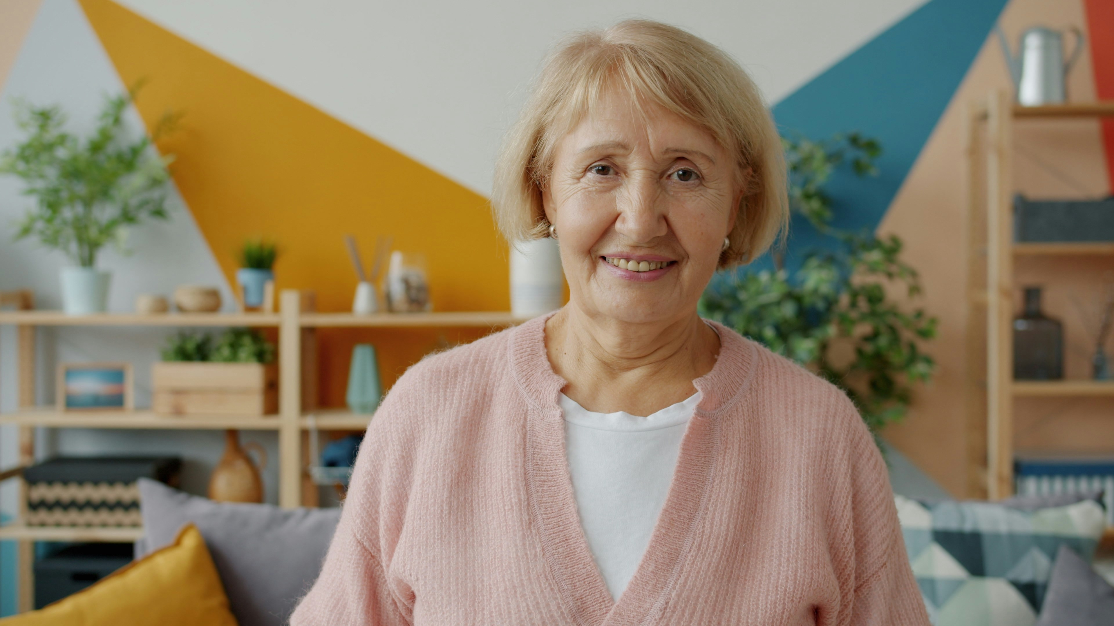 Smiling senior woman in a bright living room at home
